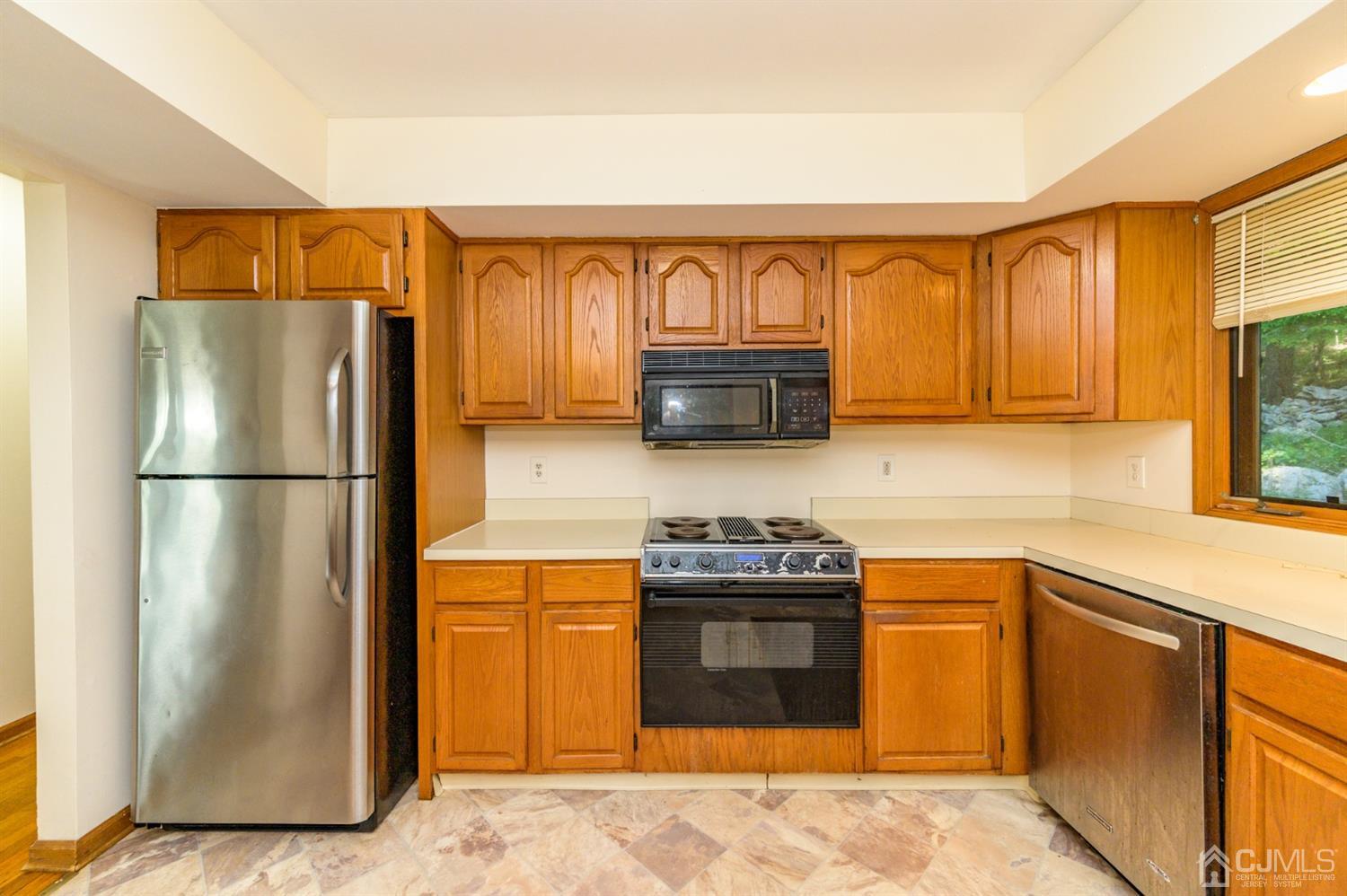 58 Forest Road Andover, NJ 07821 - Photo 13 of 34 a kitchen with stainless steel appliances granite countertop a refrigerator sink and stove