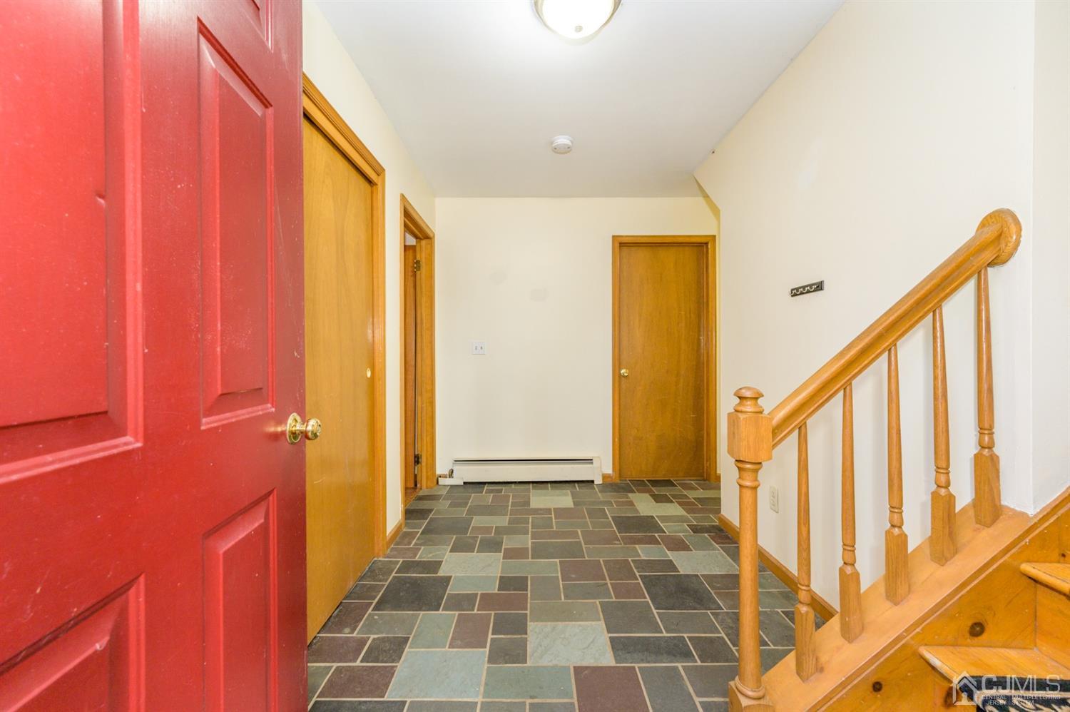 58 Forest Road Andover, NJ 07821 - Photo 3 of 34 a view of a hallway with wooden floor and staircase