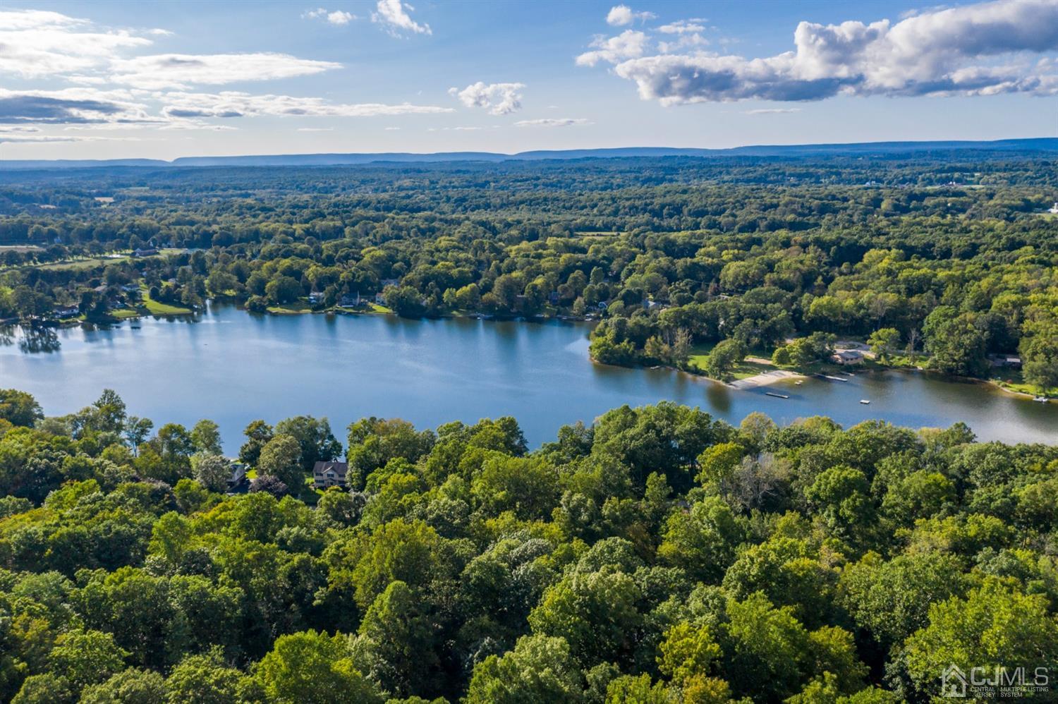 58 Forest Road Andover, NJ 07821 - Photo 33 of 34 a view of a lake with mountains in the background