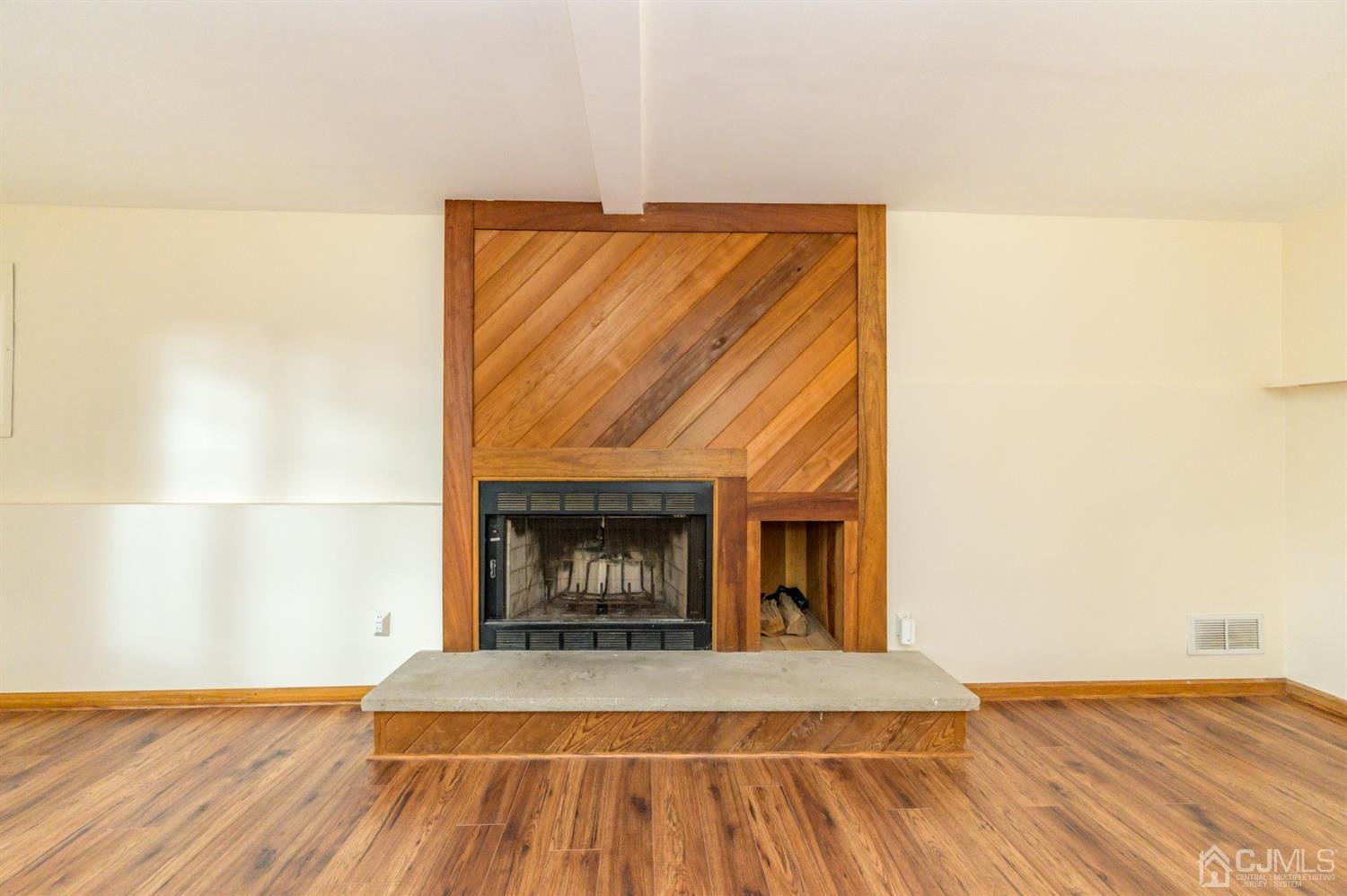 58 Forest Road Andover, NJ 07821 - Photo 6 of 34 a view of an empty room with wooden floor and a fireplace