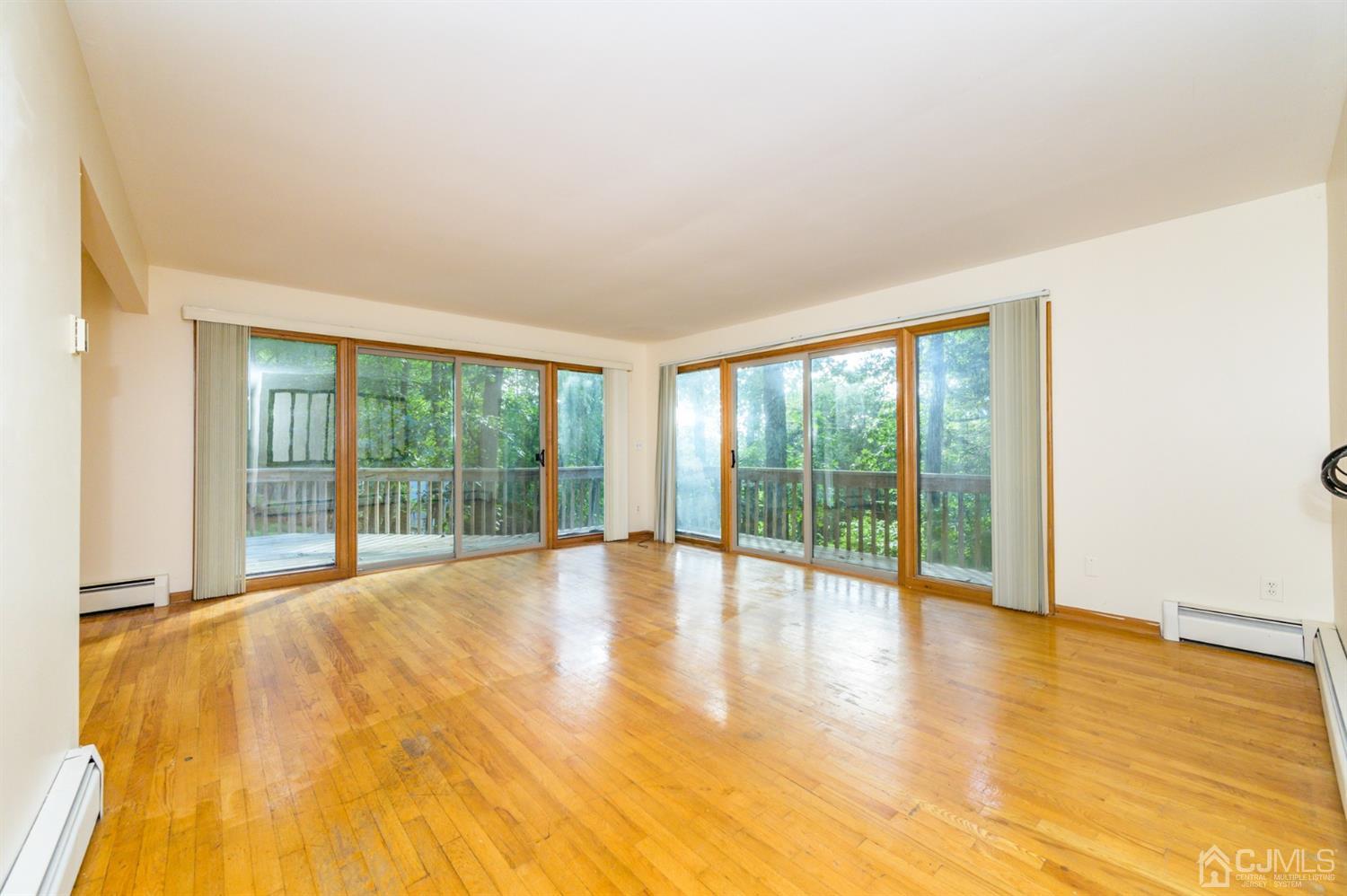 58 Forest Road Andover, NJ 07821 - Photo 9 of 34 a view of an empty room with glass door and balcony