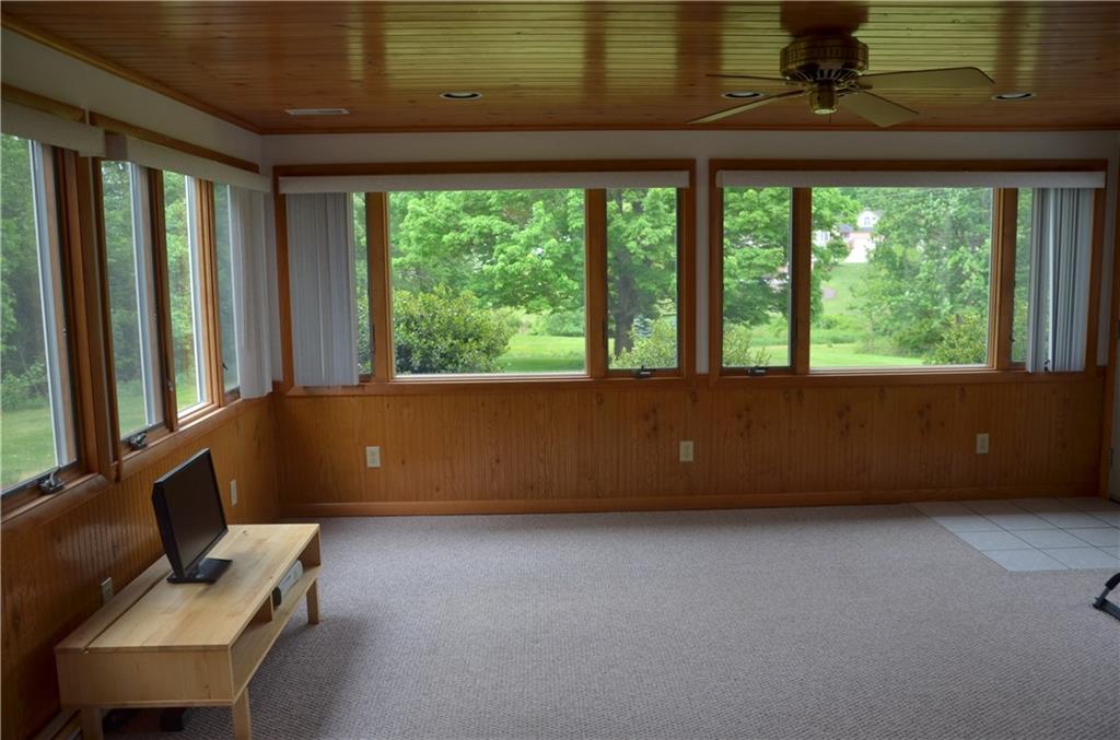 217 Cole Road Sarver, PA 16055 - Photo 12 of 14 Four seasons room with wall-wall carpeting, wood ceiling, wainscoting and walk out door to deck