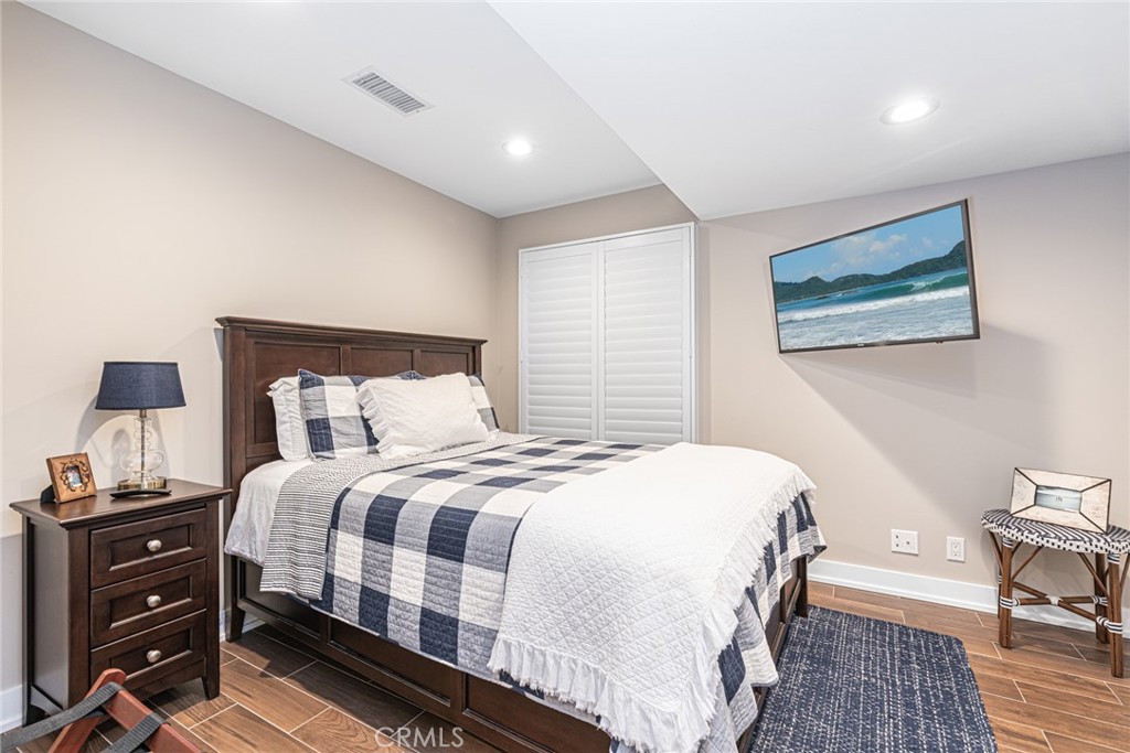 213 34th Street Newport Beach, CA 92663 - Photo 17 of 32 a bedroom with a bed and a lamp on table