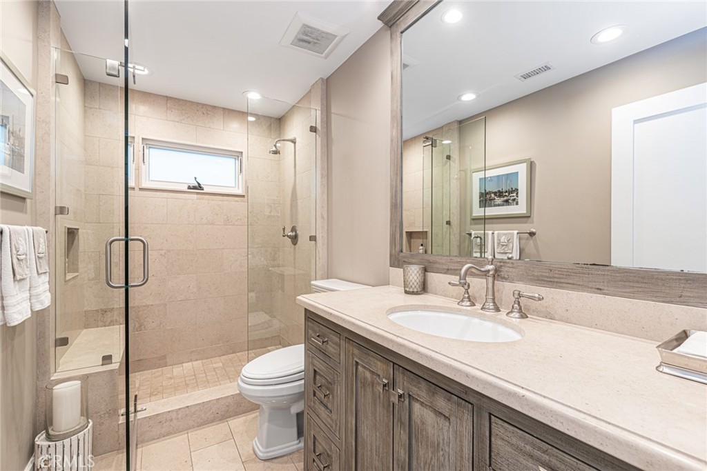 213 34th Street Newport Beach, CA 92663 - Photo 19 of 32 a bathroom with a sink a toilet and shower