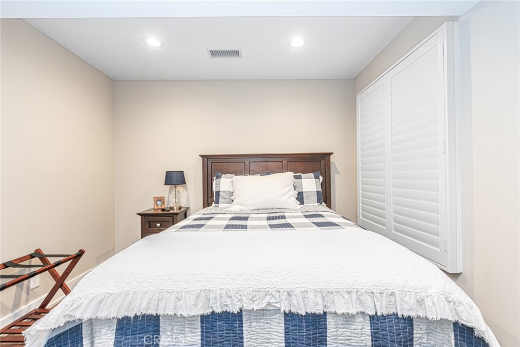 213 34th Street Newport Beach, CA 92663 - Photo 20 of 32 a large bed sitting in a bedroom next to a cabinet