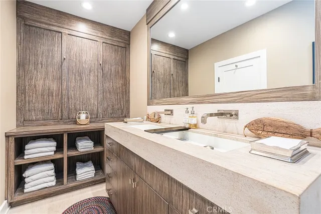 a bathroom with a granite countertop sink toilet a mirror and shower