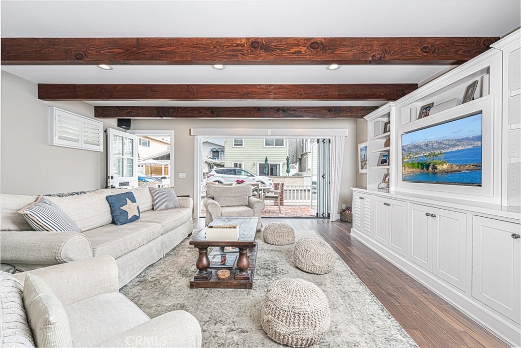 213 34th Street Newport Beach, CA 92663 - Photo 5 of 32 a living room with furniture and a flat screen tv