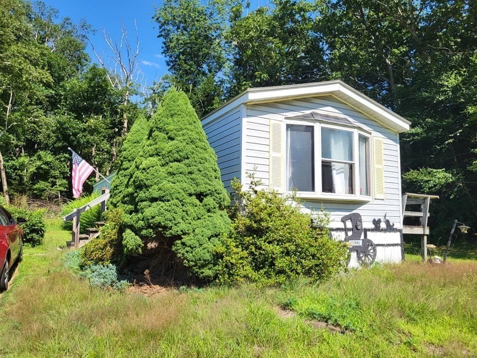 74 Old Turnpike Road Thompson, CT 06262 - Photo 12 of 18 a view of backyard with table and chairs and potted plants