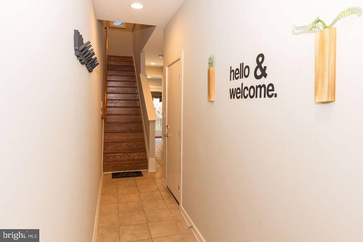 24 South Regester Street Baltimore, MD 21231 - Photo 36 of 44 a view of hallway with stairs and wooden floor