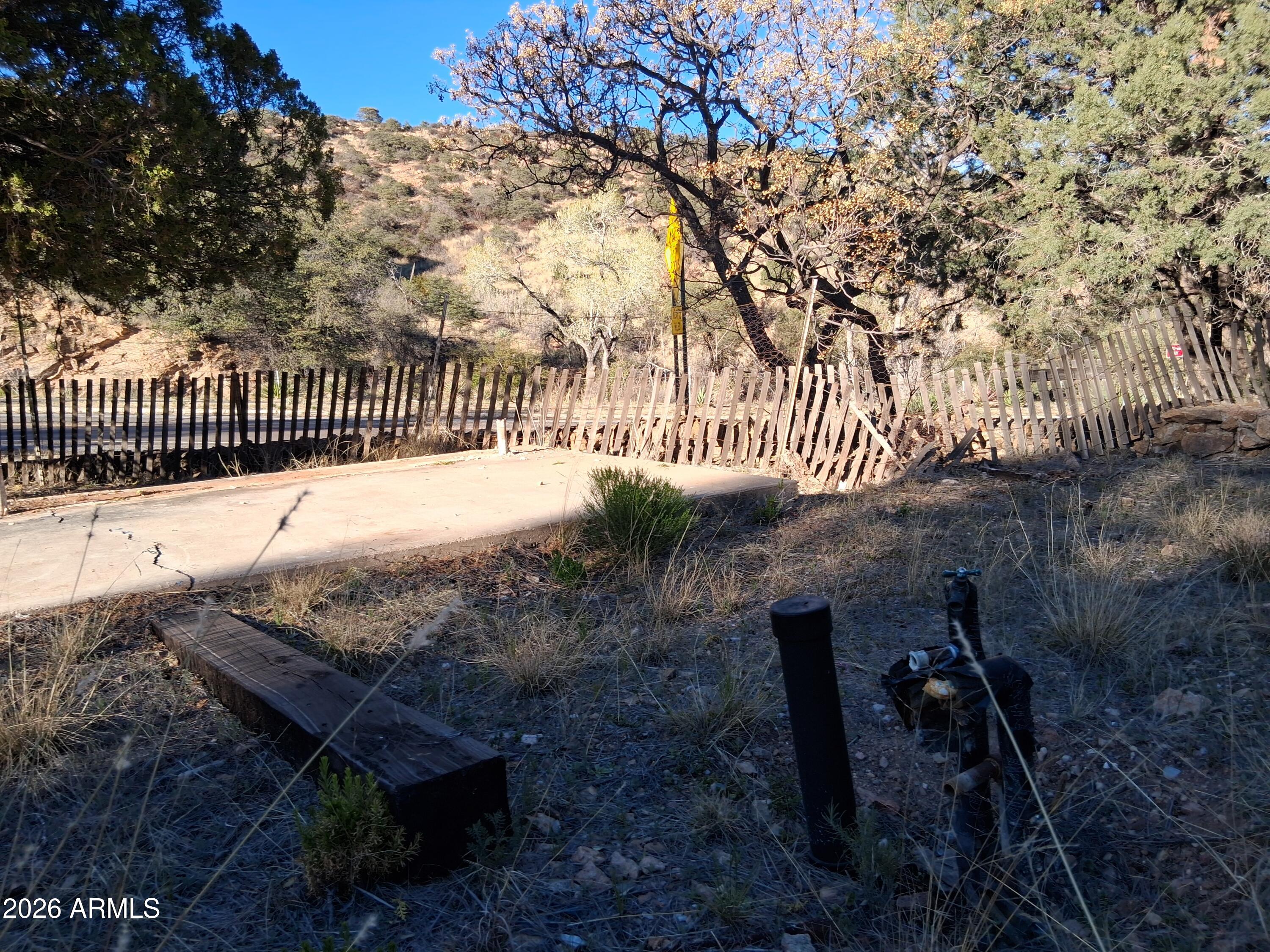 1589 Highway 80 Bisbee, AZ 85603 - Photo 12 of 18 a view of a wooden fence next to a yard
