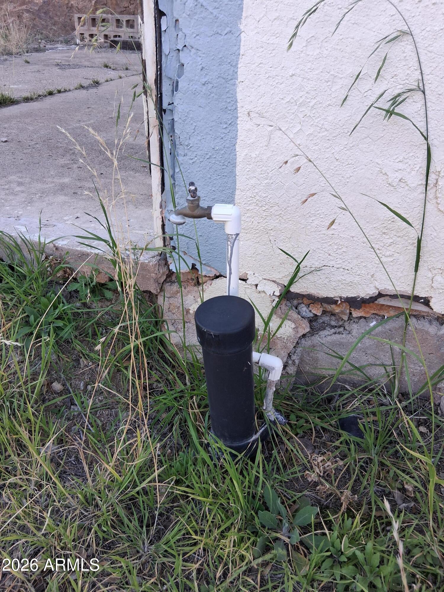 1589 Highway 80 Bisbee, AZ 85603 - Photo 13 of 18 a view of a backyard with plants and a fountain