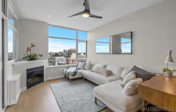 a living room with furniture kitchen view and a fireplace