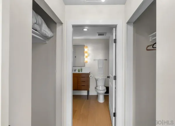 a bathroom with a granite countertop toilet and a shower