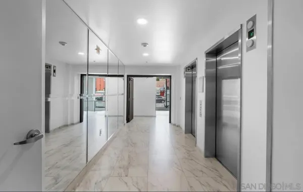 a view of a hallway with wooden shelves