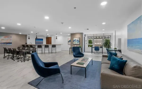 a living room with furniture kitchen view and a large window