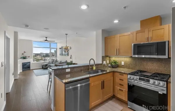 a kitchen with stainless steel appliances granite countertop a sink stove and cabinets