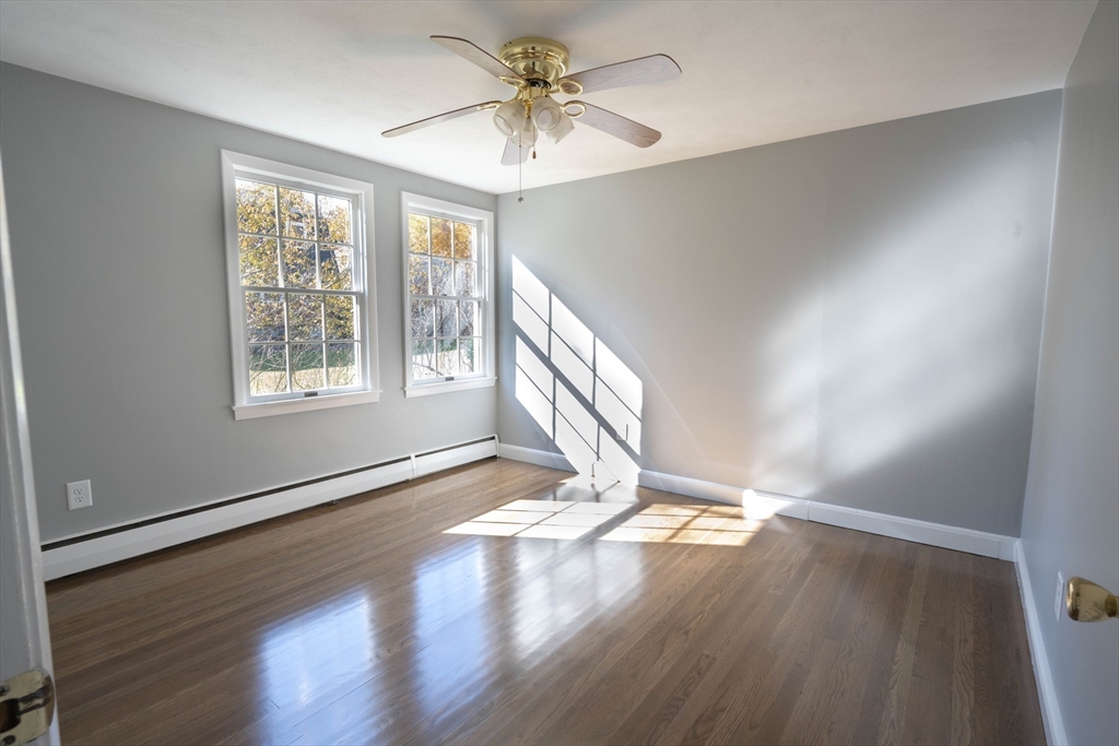 197 Andover Road Billerica, MA 01821 - Photo 21 of 42 a view of an empty room with window and wooden floor