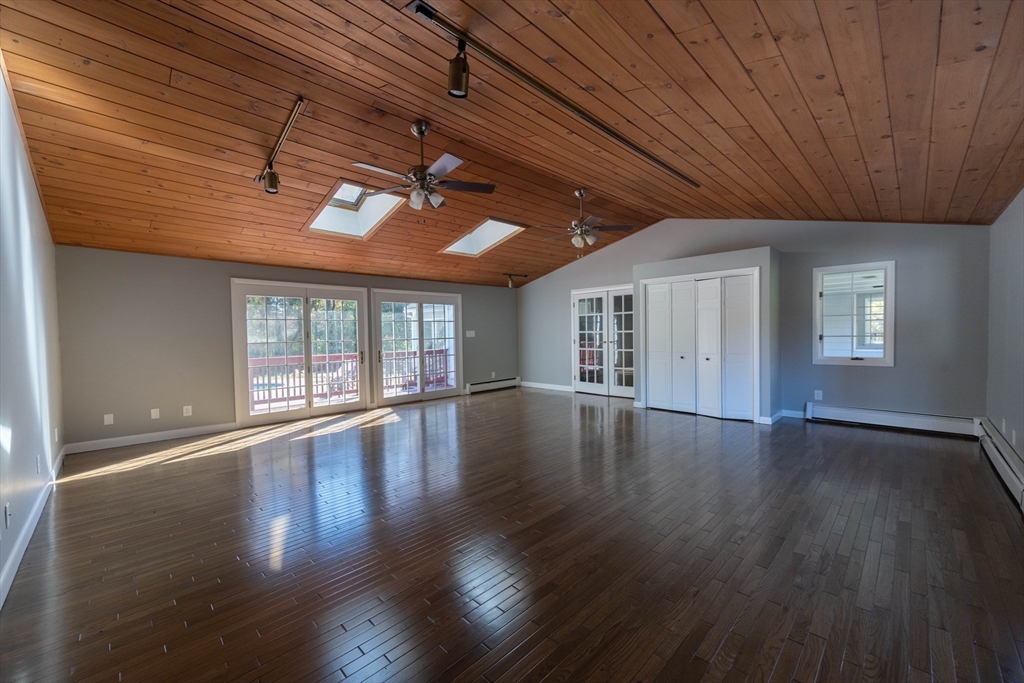 197 Andover Road Billerica, MA 01821 - Photo 8 of 42 a view of an empty room with wooden floor and windows