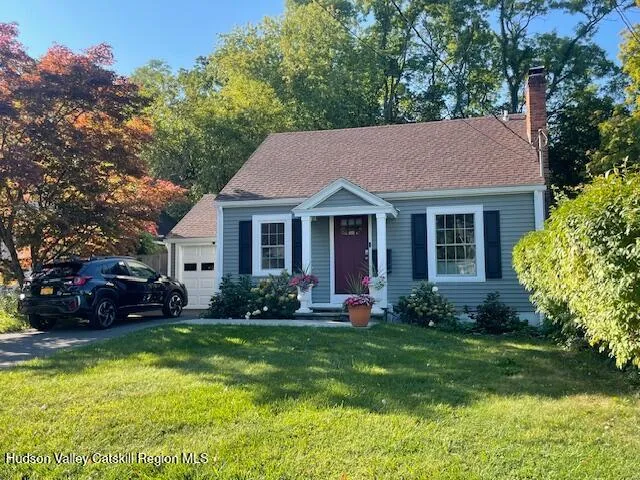 a front view of a house with a yard and porch