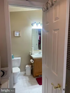 a bathroom with a toilet sink and mirror