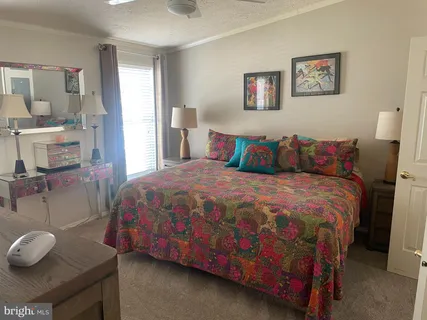 a large bed sitting in a bedroom next to a window with wooden floor