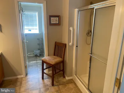 a bathroom with a shower and a mirror
