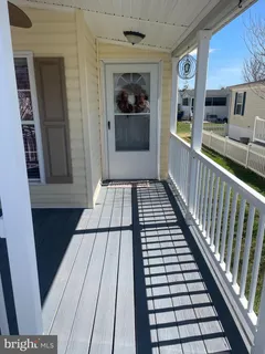 a view of a hallway view with wooden floor and staircase