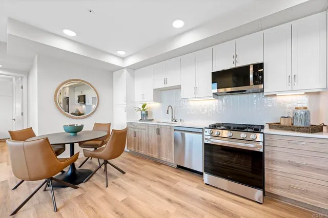 a kitchen with a stove a microwave and wooden cabinets