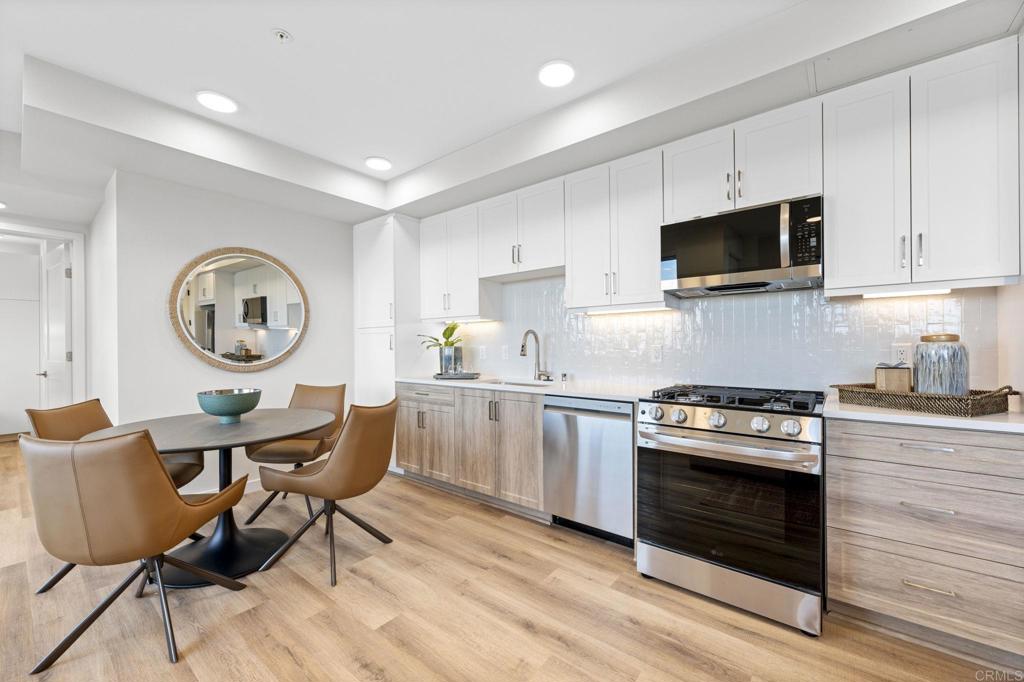 a kitchen with a stove a microwave and wooden cabinets