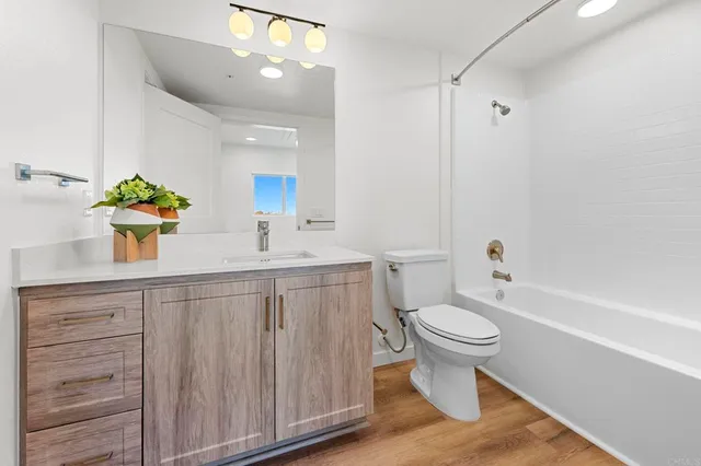 a bedroom with a bed and a night stand