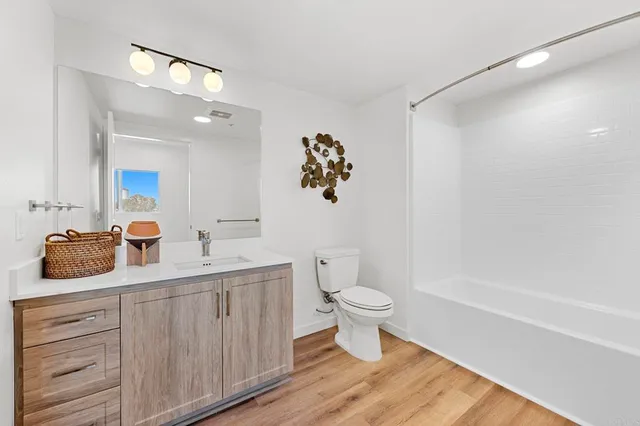 a living room with furniture and view of kitchen
