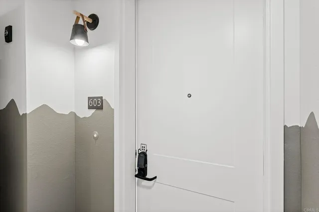 a kitchen with stainless steel appliances a table and chairs in it