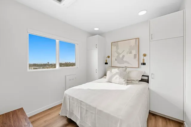 a kitchen with stainless steel appliances granite countertop a refrigerator a stove and a wooden floors