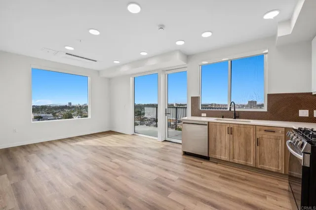 a view of a hallway with wooden floor and closet