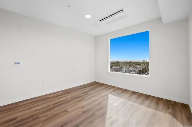 a large white kitchen with stainless steel appliances granite countertop a stove and a refrigerator
