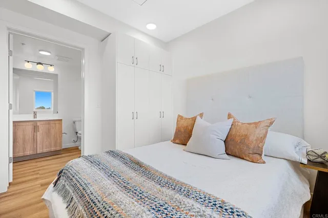 a bedroom with a bed and a wooden floor