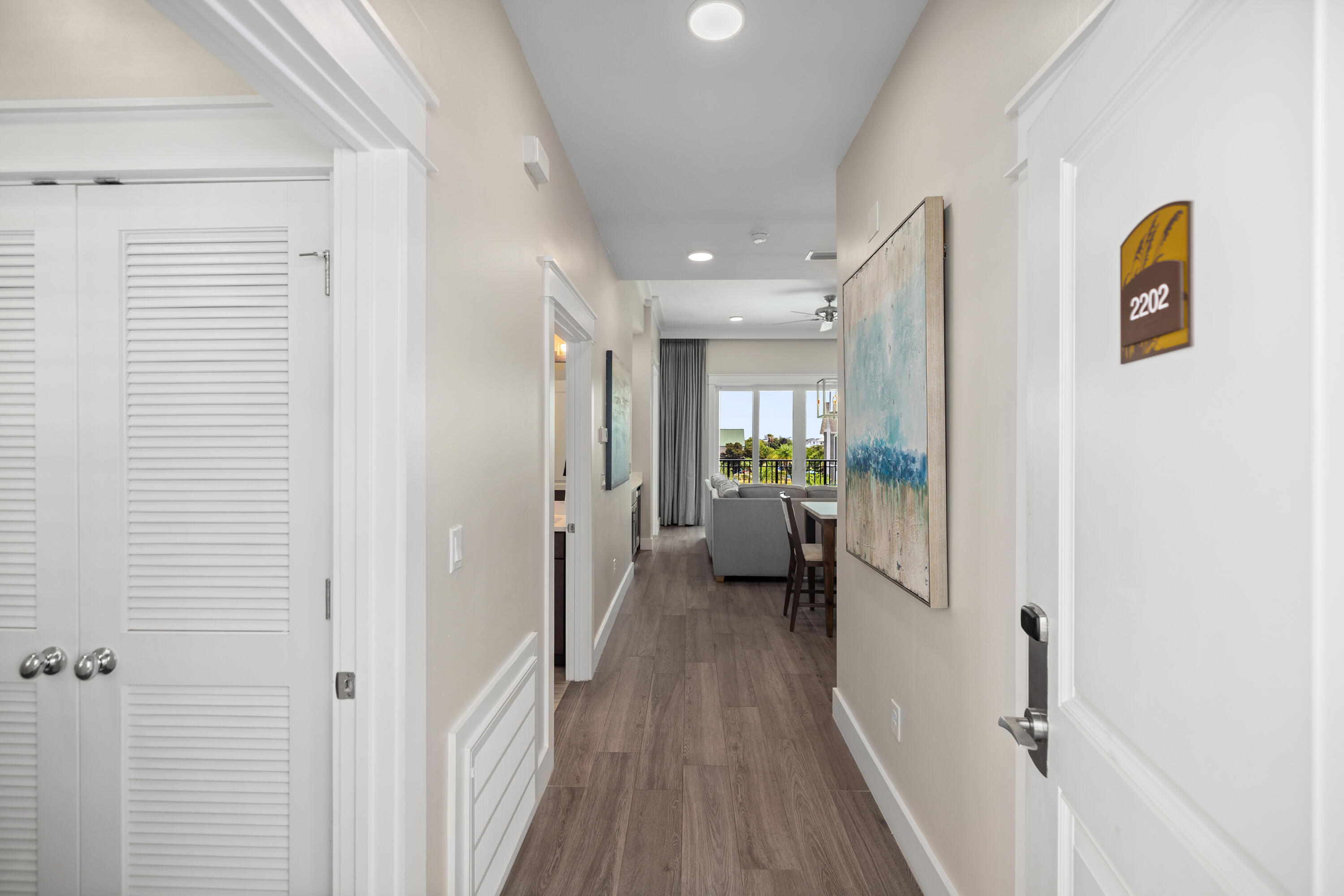 201 Henderson Resort Way, Unit 2202 Destin, FL 32541 - Photo 2 of 48 a view of a hallway view with wooden floor and a living room