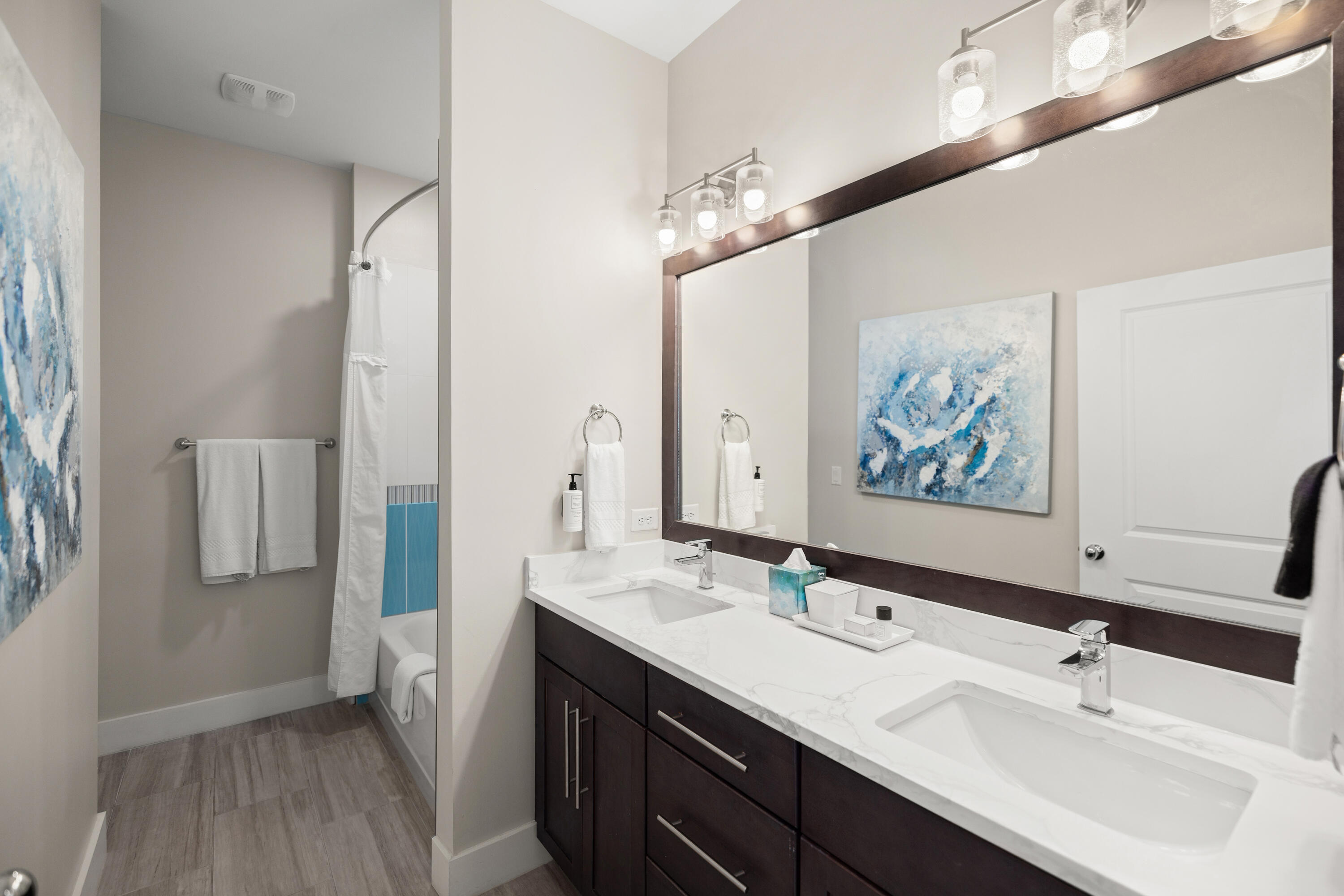 201 Henderson Resort Way, Unit 2202 Destin, FL 32541 - Photo 22 of 48 a bathroom with a double vanity sink a mirror and a shower