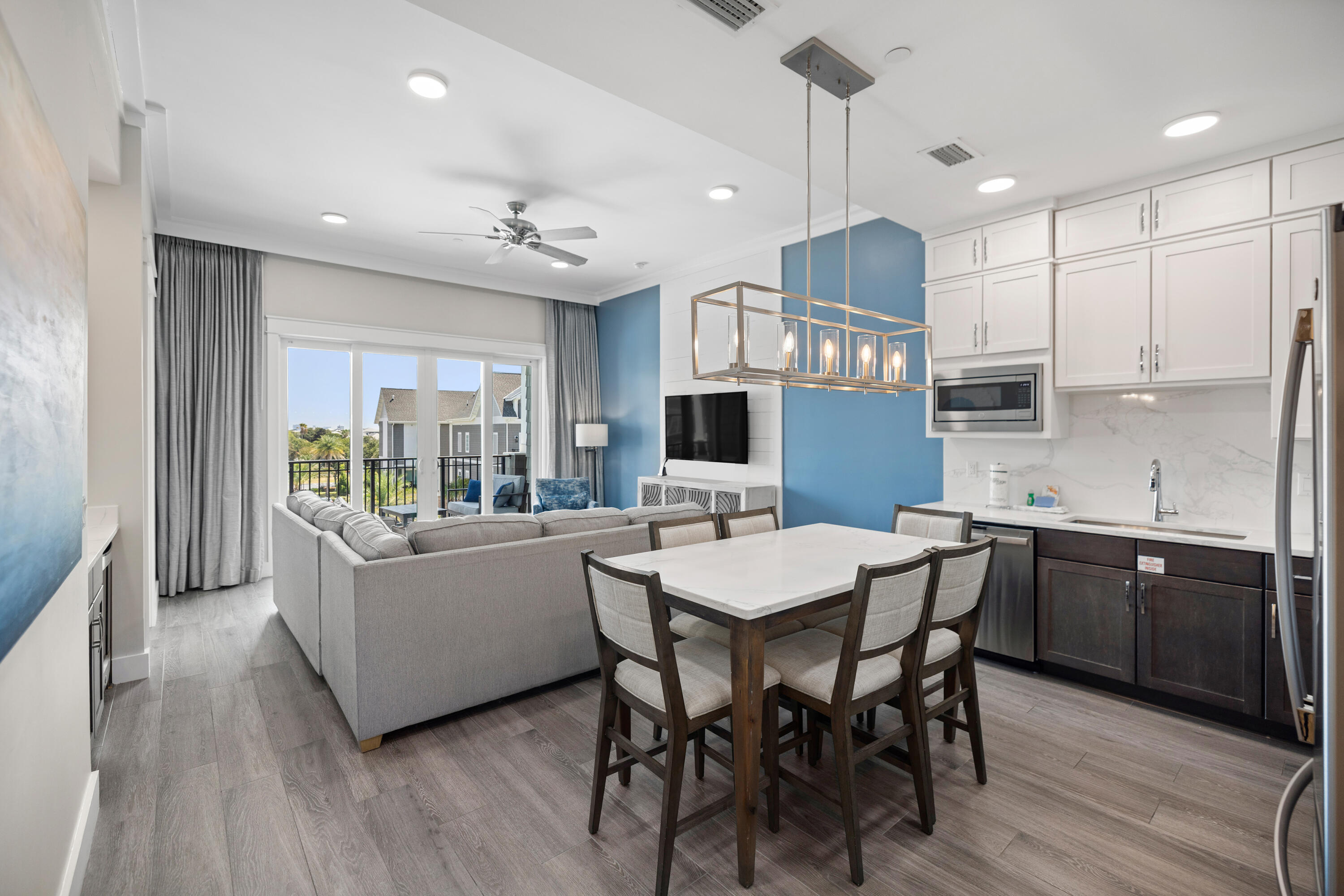 201 Henderson Resort Way, Unit 2202 Destin, FL 32541 - Photo 3 of 48 a kitchen with stainless steel appliances granite countertop a kitchen island hardwood floor sink stove dining table and chairs