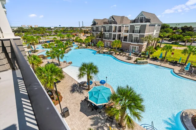 swimming pool view with plants and large trees