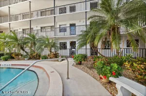 a house with palm tree in front of it