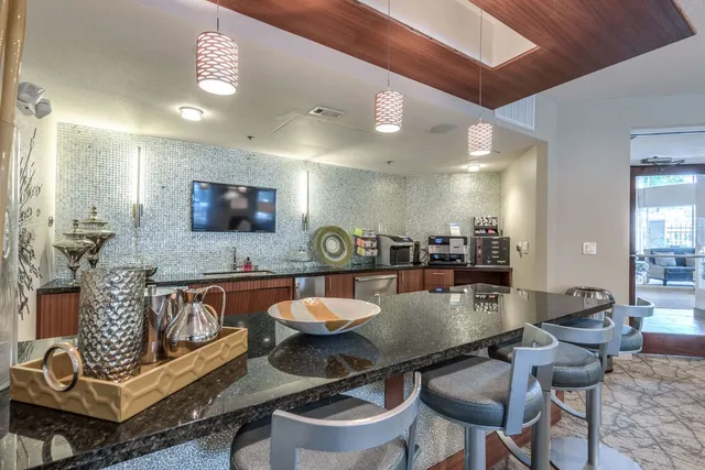 a kitchen with a dining table and chairs