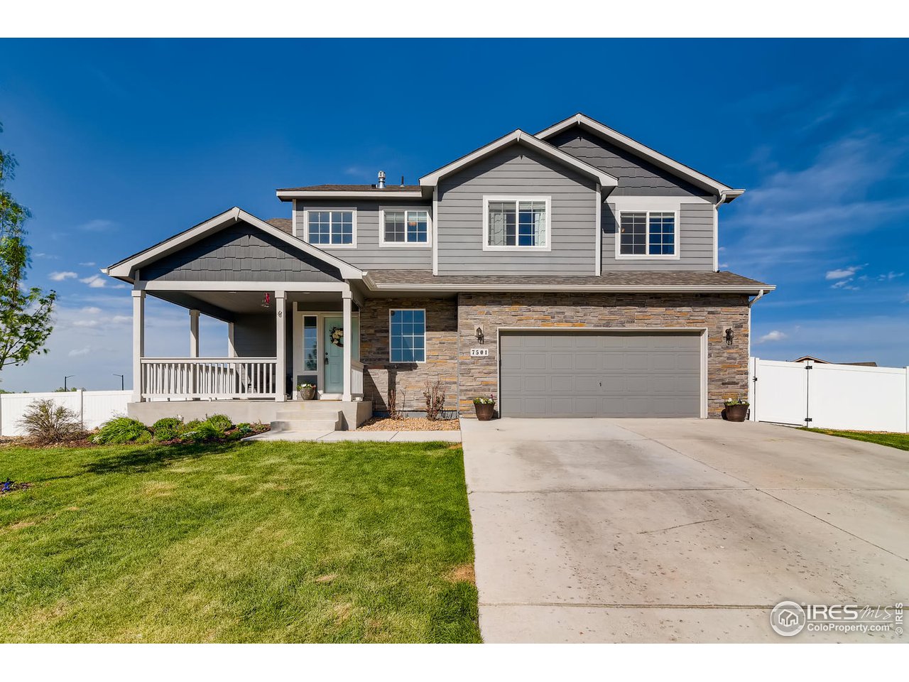 7501 21st Street Greeley, CO 80634 - Photo 1 of 27 a front view of a house with a yard