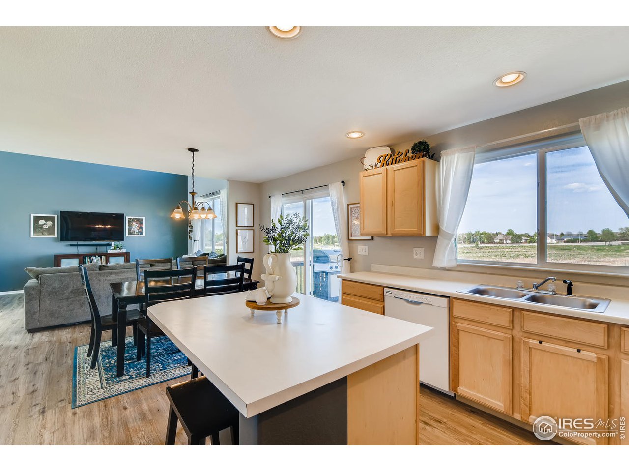 7501 21st Street Greeley, CO 80634 - Photo 11 of 27 a kitchen with a sink refrigerator and cabinets