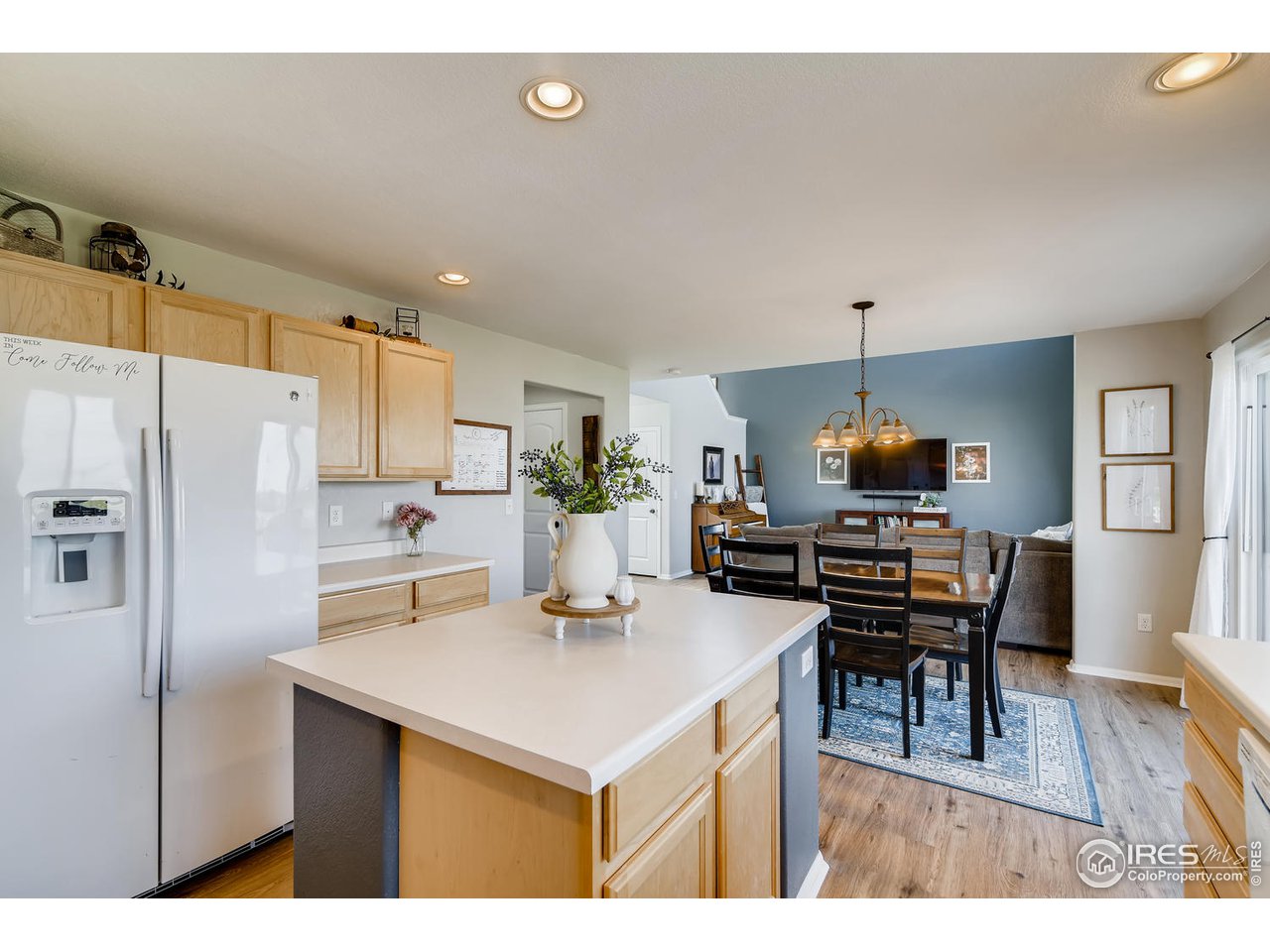 7501 21st Street Greeley, CO 80634 - Photo 12 of 27 a kitchen with a table chairs refrigerator and cabinets