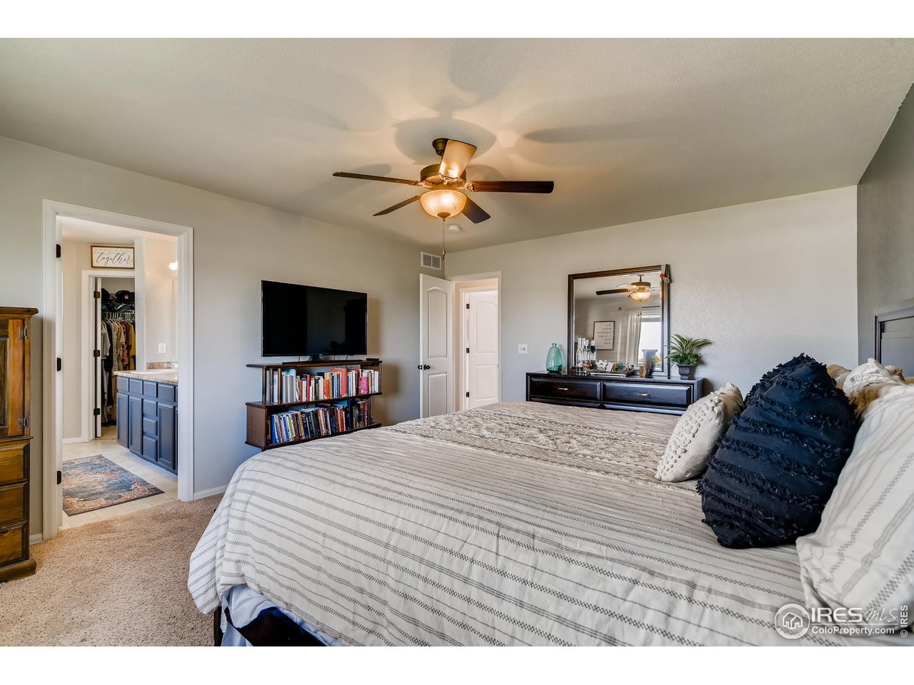7501 21st Street Greeley, CO 80634 - Photo 14 of 27 a bedroom with a bed and a flat screen tv