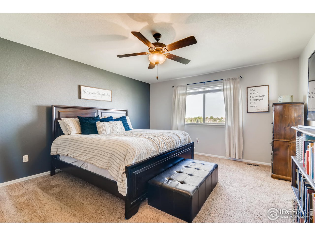 7501 21st Street Greeley, CO 80634 - Photo 15 of 27 a bedroom with a bed and a flat screen tv