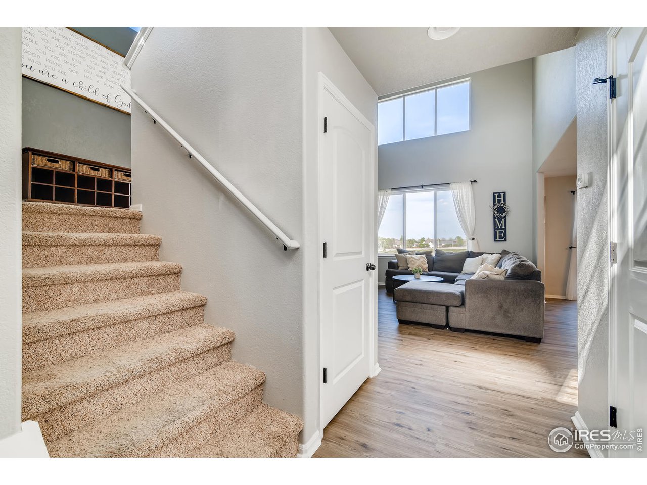 7501 21st Street Greeley, CO 80634 - Photo 17 of 27 a view of living room and kitchen with furniture and wooden floor