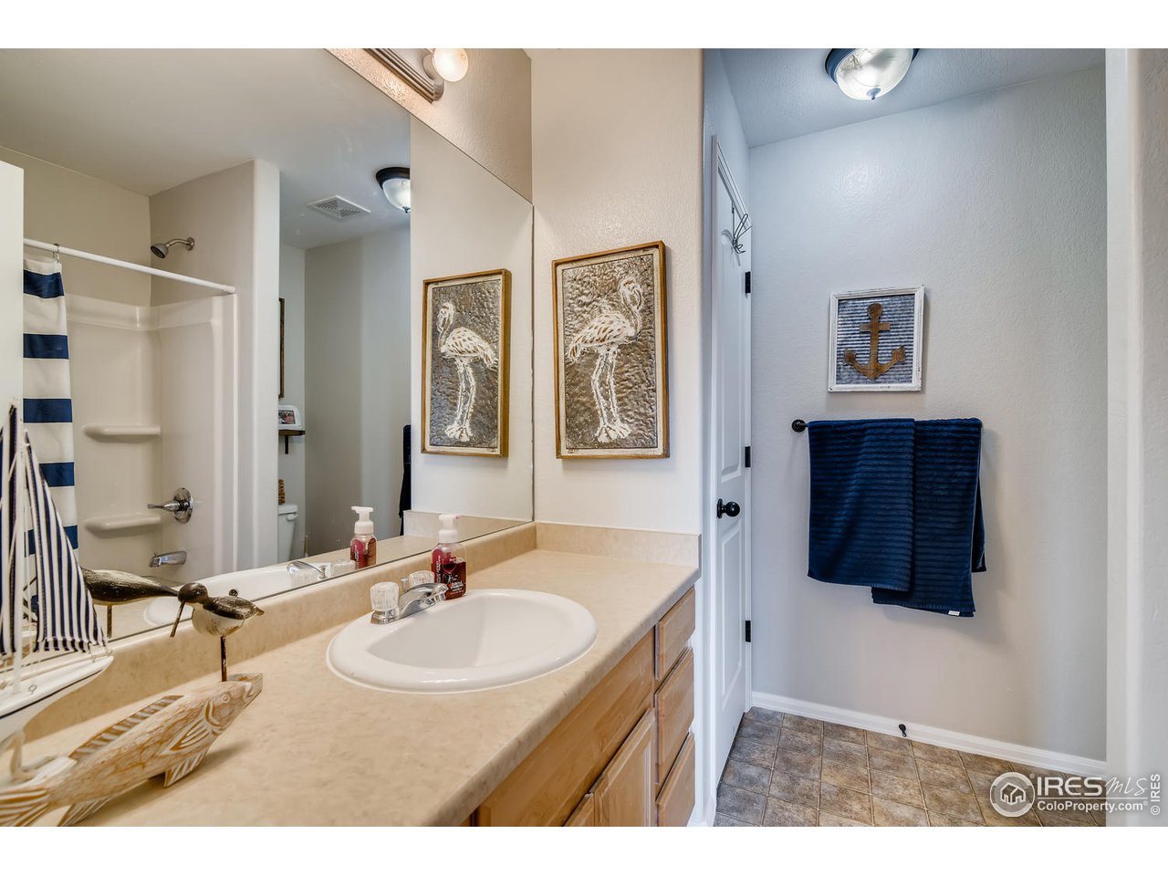 7501 21st Street Greeley, CO 80634 - Photo 18 of 27 a bathroom with a sink double vanity and a mirror