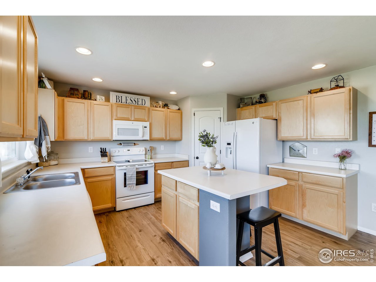 7501 21st Street Greeley, CO 80634 - Photo 2 of 27 a kitchen with white cabinets and white appliances